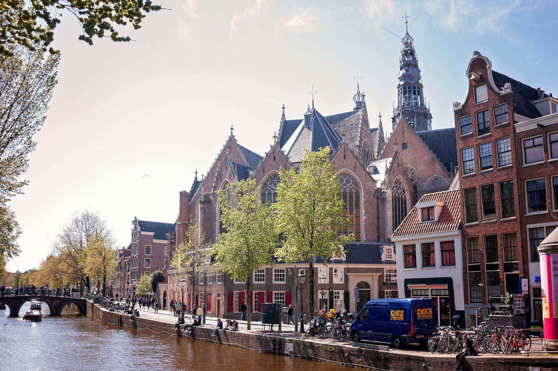 The historic Oude Kerk in Amsterdam, showcasing its stunning Gothic architecture and intricate stained glass windows.