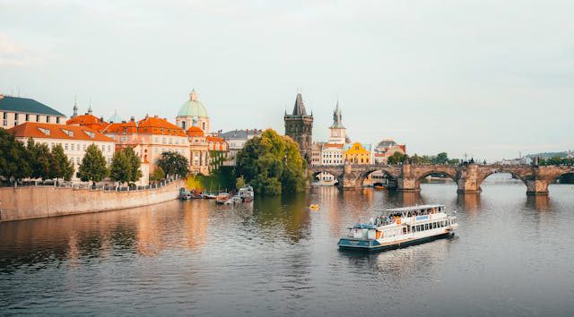 Scenic boat cruise on Vltava River with Prague skyline